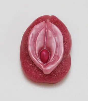A pink condom with the design of an erotic woman 's vagina.