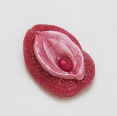 A pink condom with the design of an erotic symbol.