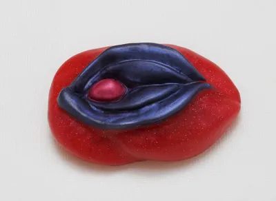 A red and blue jelly candy with an open mouth.