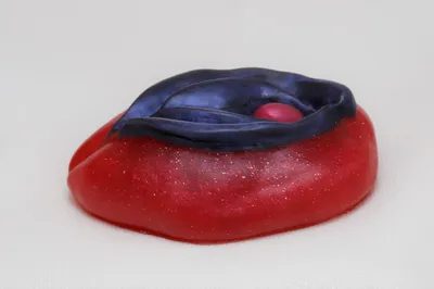 A red and blue object sitting on top of a table.