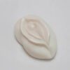 A white piece of plastic with a flower design.