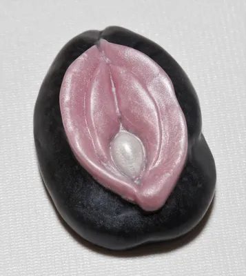 A black and white picture of a pink condom.