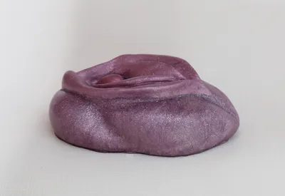 A purple hat is sitting on the ground.