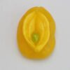 A yellow flower with green center on white surface.