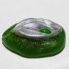 A green and silver jelly bean sitting on top of a table.