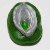 A green and silver bean is sitting on the table.