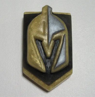 A picture of the knights helmet on a pin.