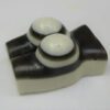 A pair of candles sitting on top of a chocolate block.