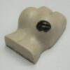 A white object with black spots on it.
