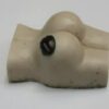A white toy with two black eyes and a breast.