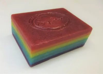 A rainbow colored soap sitting on top of a counter.