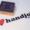 A rubber stamp sitting next to the words " i love handjobs ".