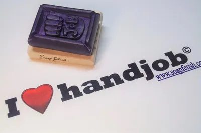A rubber stamp sitting next to the words " i love handjobs ".