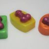 Three different colored candies are sitting on a table.
