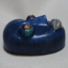 A blue car with colored wheels on top of it.
