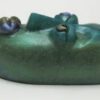 A green object with two blue flowers on it.