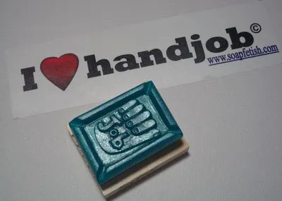 A rubber stamp with scissors on it sitting next to the word " handjob ".