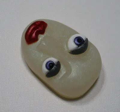 A white face with two eyes and red nose.