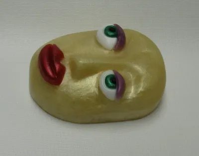 A yellow face with eyes and mouth on top of it.
