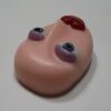 A close up of a toy head on a table