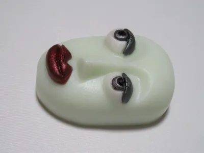 A white face with red lips and black eyes.