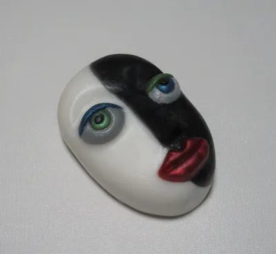A white face with black and red eyes.