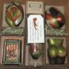 A box of six different items in the shape of apples.
