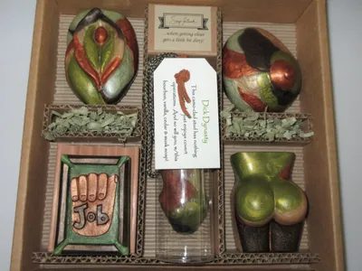 A box of six different items in the shape of apples.