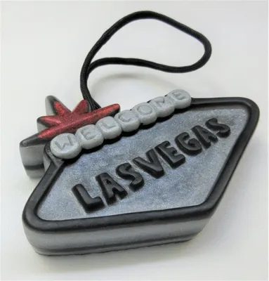 A las vegas sign ornament with the word " welcome " on it.