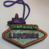 A green and purple sign that says " welcome las vegas ".