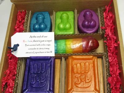 A box of soap with different colored soaps in it.