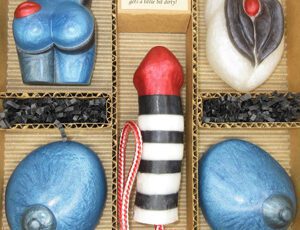A box of chocolates with a red and black striped candle.