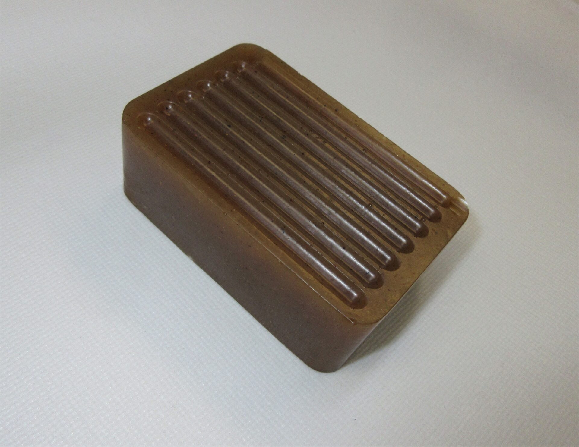A brown soap bar sitting on top of a counter.