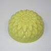 A yellow candle is sitting on the table