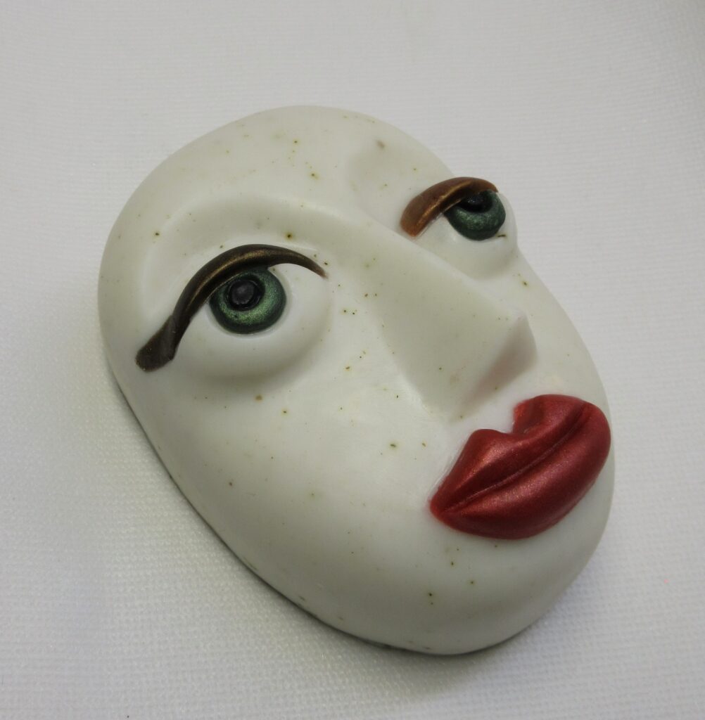 Stylized soap bar shaped like a face.